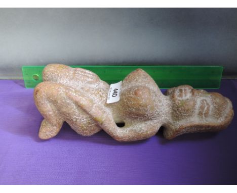 A jade/hardstone figure modelled as a woman kneeling