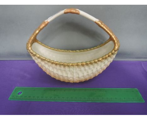 A Royal Worcester bowl of woven basket form having blush ivory ground, numbered 2526