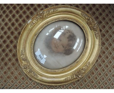 An oval print, portrait study, young woman in gilt effect frame
