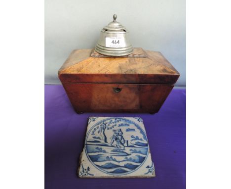 An early 19th century mahogany tea caddy of sarcophagus shape on bun feet, a 19th century pewter inkpot and a 19th century bl