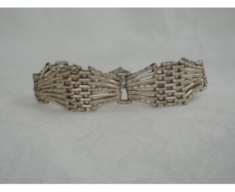 An HM silver seven bar shaped gate bracelet having a padlock clasp