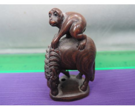 A treen netsuke modelled as monkey on horse