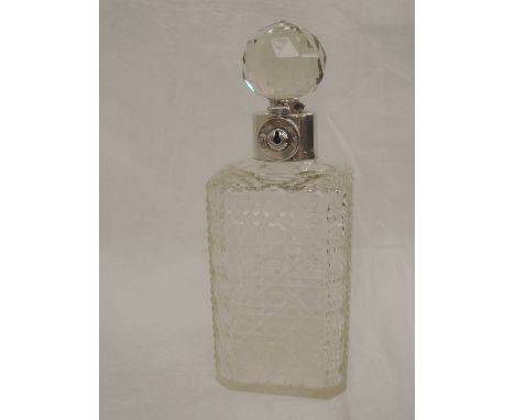 A cut glass whisky decanter having a silver collar with stopper lock, Birmingham 1927, possibly James Grinsell & Sons