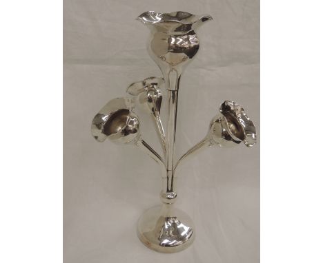 A silver epergne having a central flute in the form of a stylised poppy seed head with shaped rim encircled by three similar 