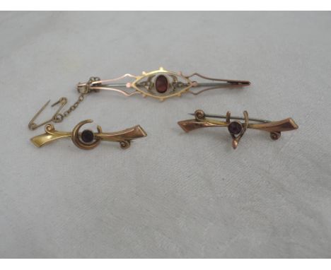 Three yellow metal bar brooches stamped 9ct having ruby and garnet decoration