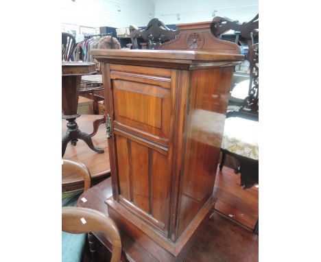 A late Victorian mahogany pot cupboard having raised  back with panel door and plinth base