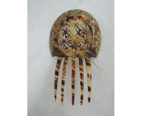 A Victorian tortoise shell hair comb having pierced, gilt and applique shell decoration