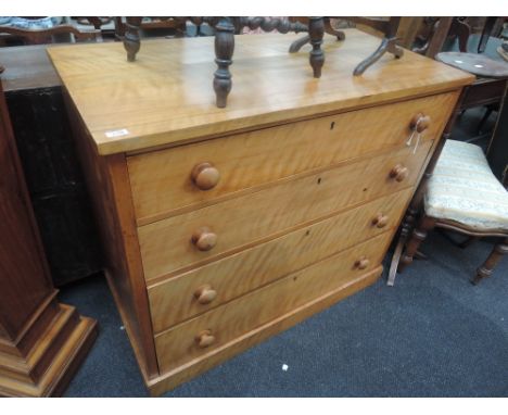 A 19th century satinwood chest of four long graduated drawers on plinth base