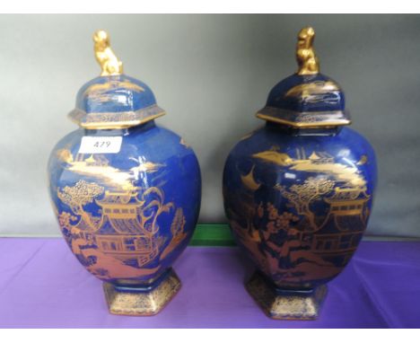 A pair of Carltonware lidded jars having gilt heightened Japanesque decoration on powder blue ground