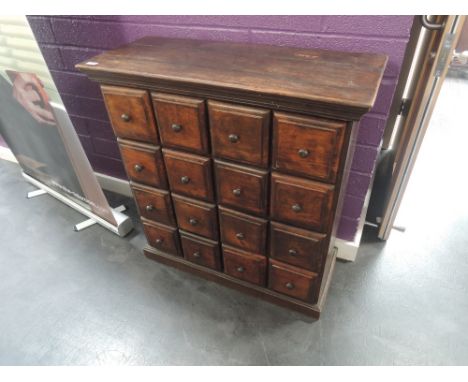 A late 20th century stained frame Eastern multi chest of small drawers on plinth base