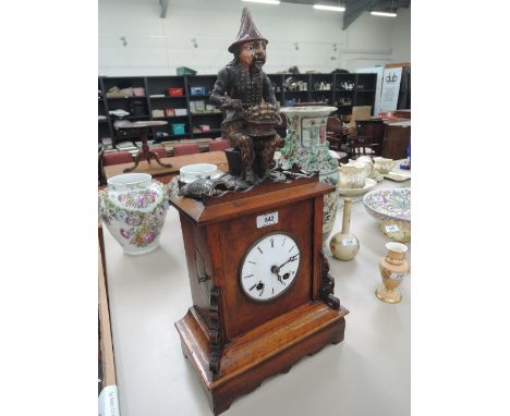 A 19th century mahogany, walnut and lime wood automaton bracket clock having mechanical finial modelled as plum eating man, w