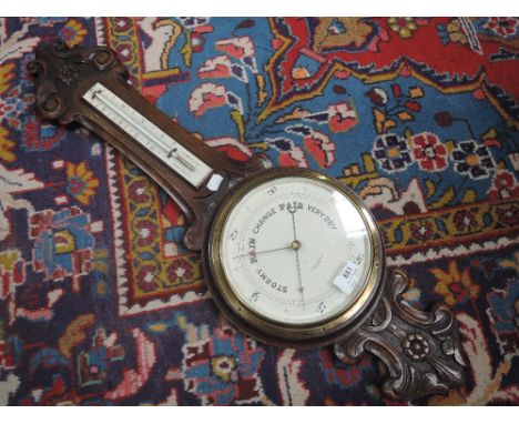 An early 20th century oak cased banjo barometer by Clarke & Ainsworth, Blackpool, having thermometer scale