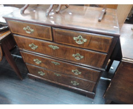 An early 19th century mahogany chest of 2 short and 3 long drawers having herringbone crossband decoration on bracket feet