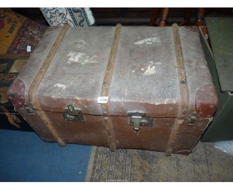 A bentwood bound trunk with leather corners, remains of luggage labels attached, 30'' wide x 18 1/2'' deep x 17' high.