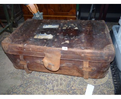 A brown leather suitcase marked 'Junior Army & Navy Ltd' with remnants of railway labels, worn condition 33'' wide x 19'' dee