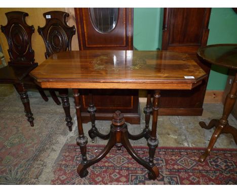 An imposing Rosewood and other woods occasional Table, the top with lightwood stringing and a centre feature with shields and