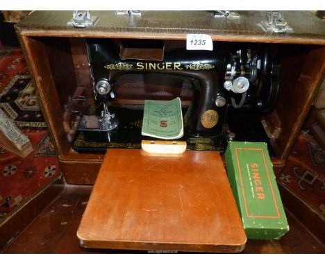 A vintage Singer (no. 99) manual sewing machine in faux crocodile wooden case, plus box of sewing components and original ins