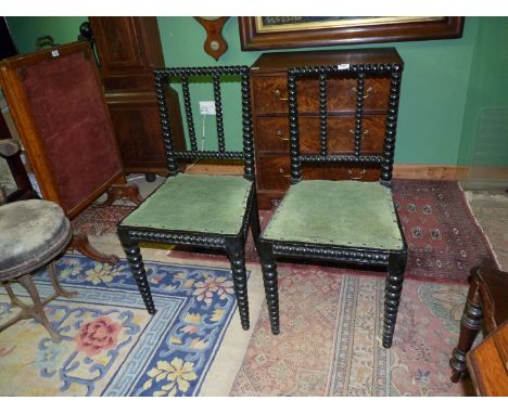 A pair of arts and crafts ebonised finish Side Chairs having tapering bobbin turned components and green fabric seat, 18'' wi