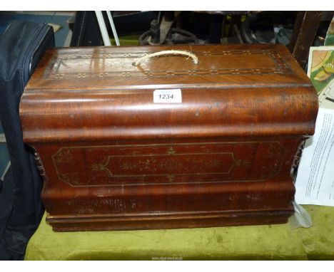 A vintage manual sewing machine in wooden Edwardian style inlaid case, with key.