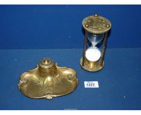 An Art Nouveau brass inkwell with holly decoration and bow, china inkwell present, plus an old brass hour timer, 16 1/4" high