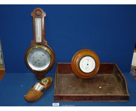 A 'Negretti & Zambra' barometer London on a carved oak base, wall hanging, and a wall hanging wooden clog having a barometer 