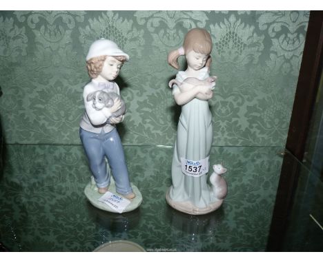 A Lladro figure of a girl with kittens and a Nao figure of a boy holding a dog.