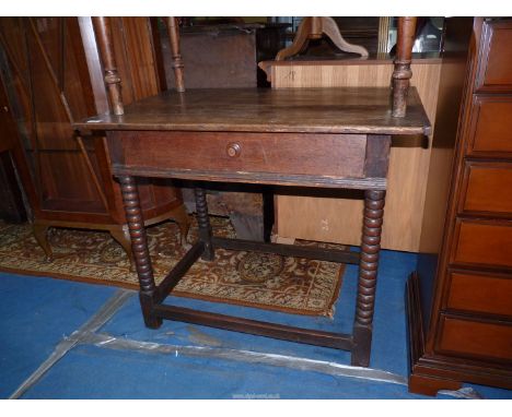 A late 18th/early 19th c. Oak side Table having a frieze drawer and standing on bobbin turned legs united by a perimeter stre