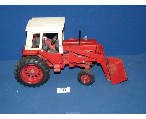 A vintage American ERTL "Farm & Country" model of a red 1/16 scale International 1568 tractor dating from around 1980, 13'' l