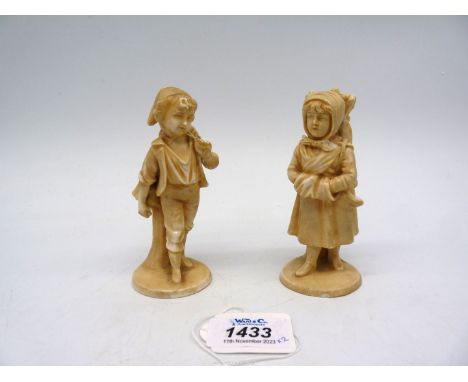 A pair of Royal Rydolstadt 19th century figures of children carrying wood in winter in a light salt glaze, 4 1/2" tall, stamp