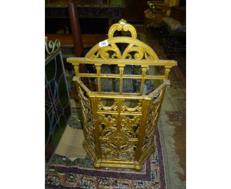 A gold painted cast iron Stick/umbrella Stand decorated with floral swags, foliage, etc., and complete with drip trays within