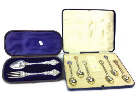 CHRISTENING FORK AND SPOON SET, maker Henry Holland, London marks, of Rococo design, the fork 17cm long, in fitted case, alon