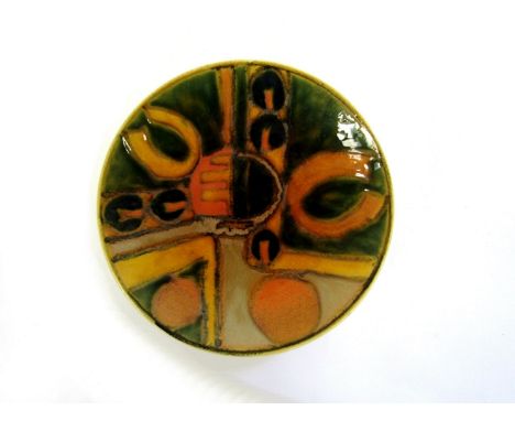 A Poole Studio dish with abstract design in ochre, green and orange, Studio Line mark to base. 20.5cm diameter