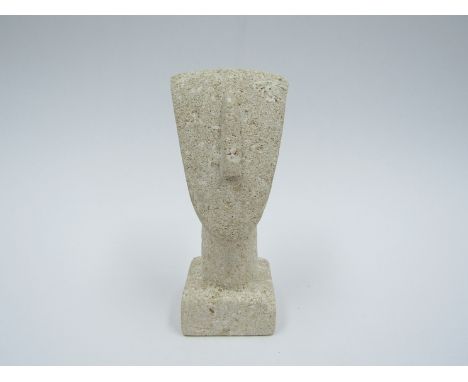 PETER HAYES (b.1946) A carved stone stylised head on plinth. Unsigned, exhibition number label to base. 13.5cm high. (chipped