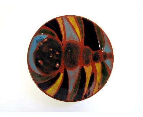 A Poole Studio dish with painted design in red, blue, black and yellow. Studio Line mark to base. 20.5cm diameter