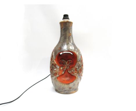 A West German floor lamp with orange lava and tan glazes over moulded scrollwork design. Interior and top light fittings. No.