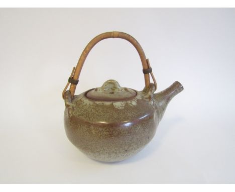 A large Aylesbury Pottery stoneware teapot with cane handle, speckled glazes. Impressed seal. 24.5cm high including handle x 