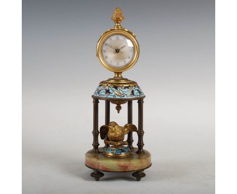 An early 20th century champleve enamel and onyx mantle clock, the silvered circular dial with Arabic numerals, raised on four