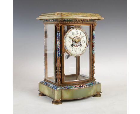 A late 19th/ early 20th century onyx and champleve enamel mantle clock, the circular enamel dial with Arabic numerals and flo