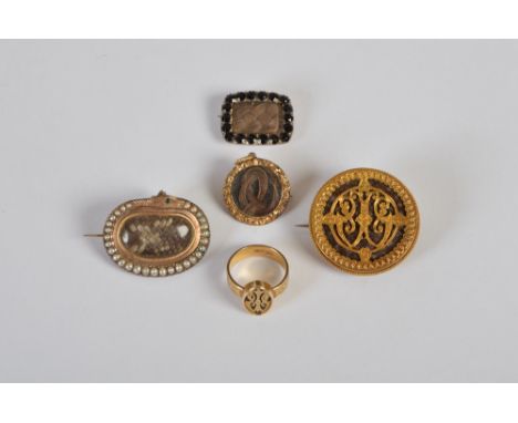 A collection of 19th century mourning jewellery, to include a 15ct gold ring, a similar circular brooch with pierced fret wor