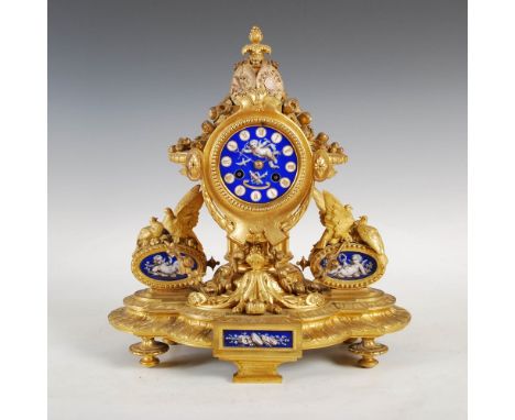 A 19th century French ormolu and porcelain mounted mantle clock, the circular blue ground porcelain dial with Roman numerals 