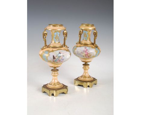 A pair of late 19th century Sevres style peach ground gilt metal mounted porcelain urns, decorated with panels of Court figur