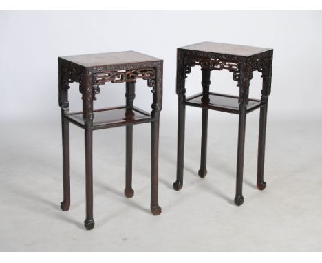 A pair of Chinese dark wood jardiniere stands, Qing Dynasty, the rectangular tops with mottled red marble inserts above pierc
