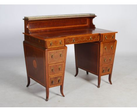 An Edwardian mahogany and satinwood banded pedestal desk by Edwards & Roberts, the rectangular top with a red and gilt tooled