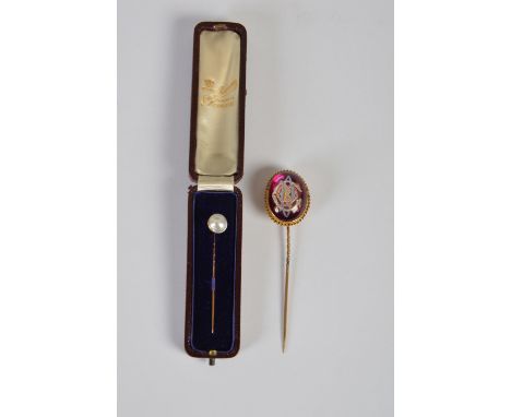 A 19th century yellow metal mounted intaglio cut rock crystal stick pin, bearing initials with painted details on a purple gr