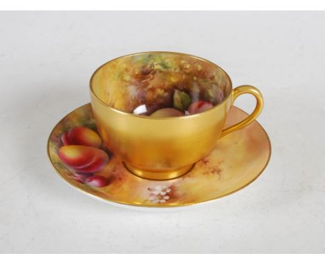 A Royal Worcester tea cup and saucer decorated by H. Everett and E. Townsend dated 1927, decorated with fruit on a mossy grou