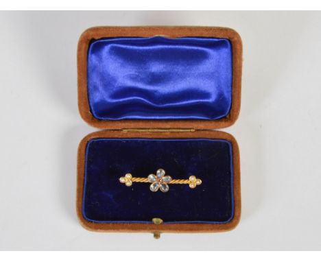 A late Victorian moonstone, pearl and ruby set bar brooch, set to yellow metal mount stamped 15ct, 3.9cm wide, in velvet line