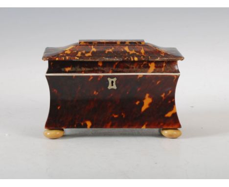 A 19th century tortoiseshell sarcophagus shaped tea caddy, the hinged cover opening to an interior with central division remo
