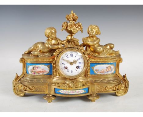 A 19th century French ormolu and porcelain mounted mantle clock, the convex circular enamel dial with Arabic and Roman numera