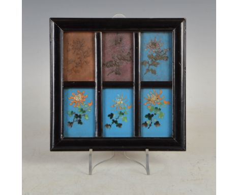 A Japanese cloisonne plaque depicting the six stages of the art of cloisonne enamelling, Meiji Period, mounted in ebonised fr