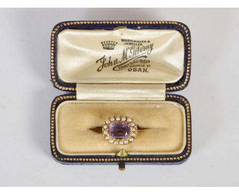 A late 19th/ early 20th century amethyst and pearl cluster brooch, set with a rectangular cushion faceted amethyst surrounded